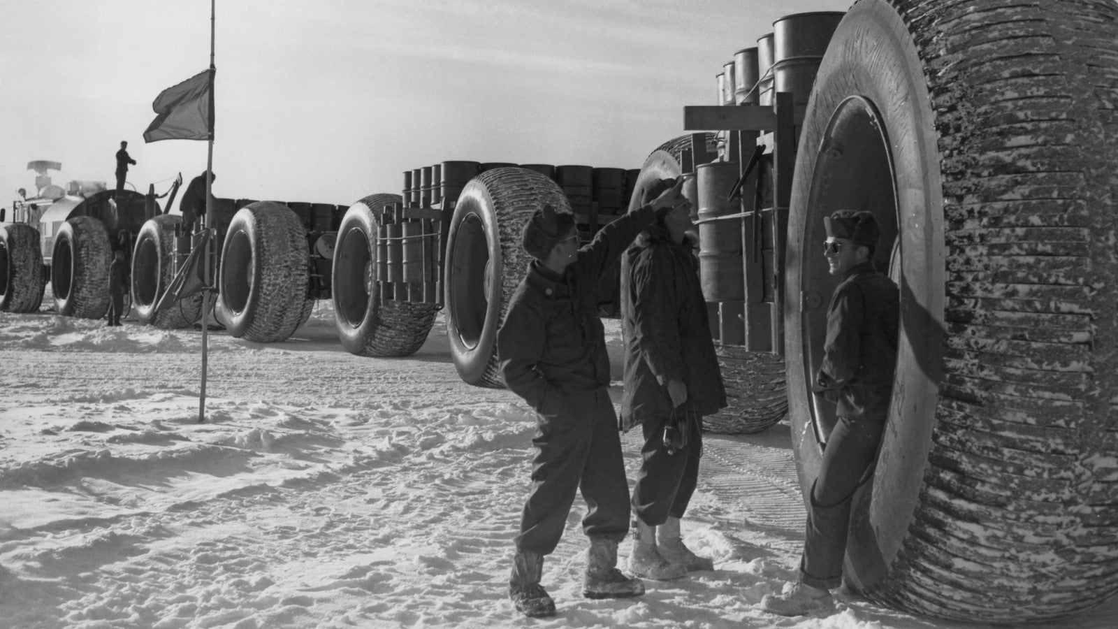 A photo of soldiers supported by the LCC-1's 10-foot wheels. 